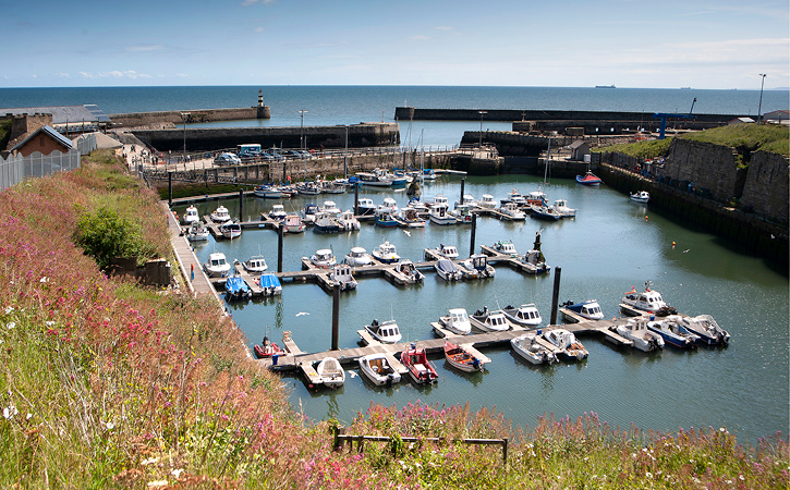 view of Seaham Marina with boats in harbour and lighthouse in background